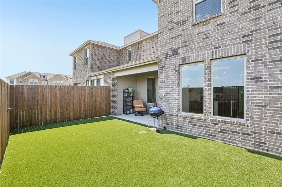 Fenced backyard with a patio area Fenced backyard with a patio area