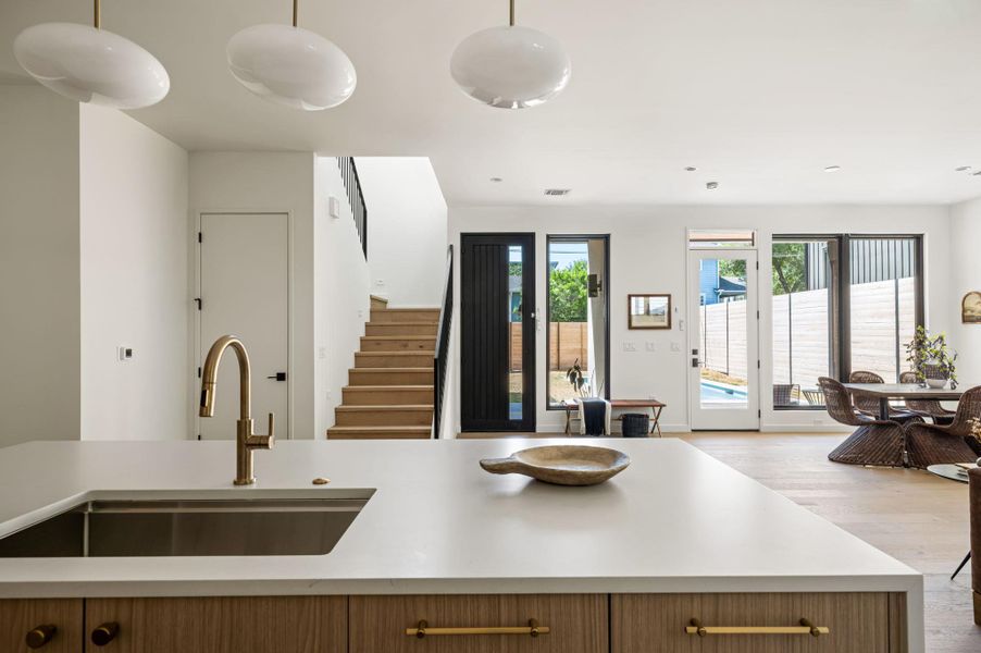 Gleaming wood floors and crisp white walls frame a modern, light-filled open layout.