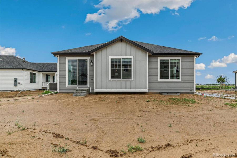 Front exterior of a new home in Farmlore, Brighton, CO, highlighting curb appeal (Image 21).
