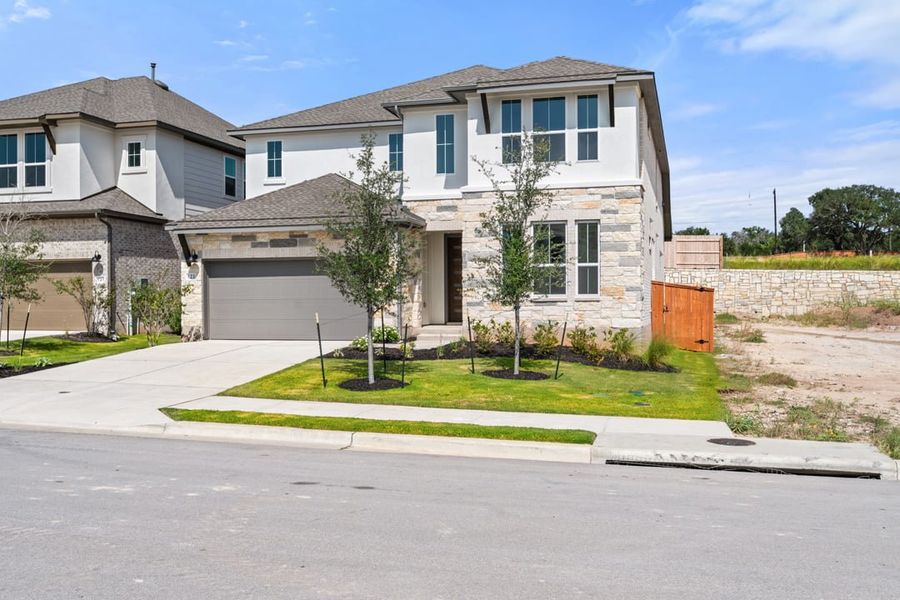 Front exterior of a new home in Park Collection at Lariat, Liberty Hill, TX, highlighting curb appeal (Image 23). Front exterior of a new home in Park Collection at Lariat, Liberty Hill, TX, highlighting curb appeal (Image 23).