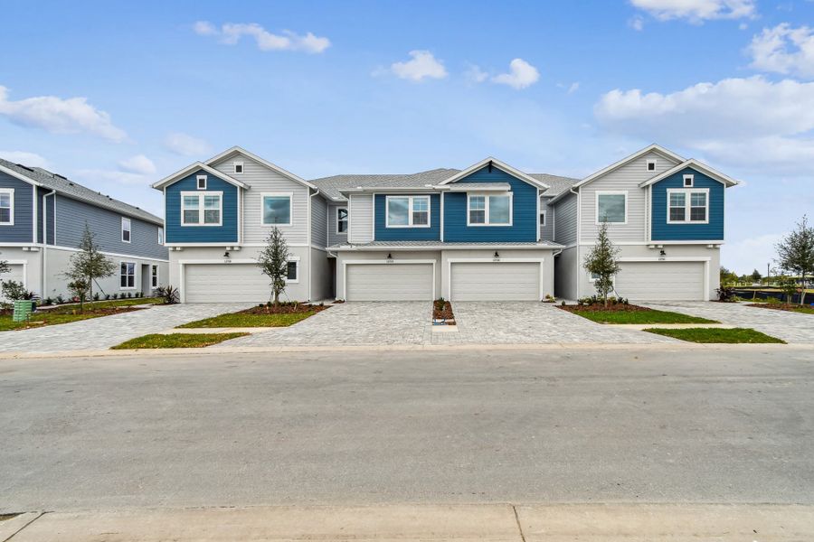 Front exterior of a new home in North River Ranch – Townhomes, Parrish, FL, highlighting curb appeal (Image 1). Front exterior of a new home in North River Ranch – Townhomes, Parrish, FL, highlighting curb appeal (Image 1).