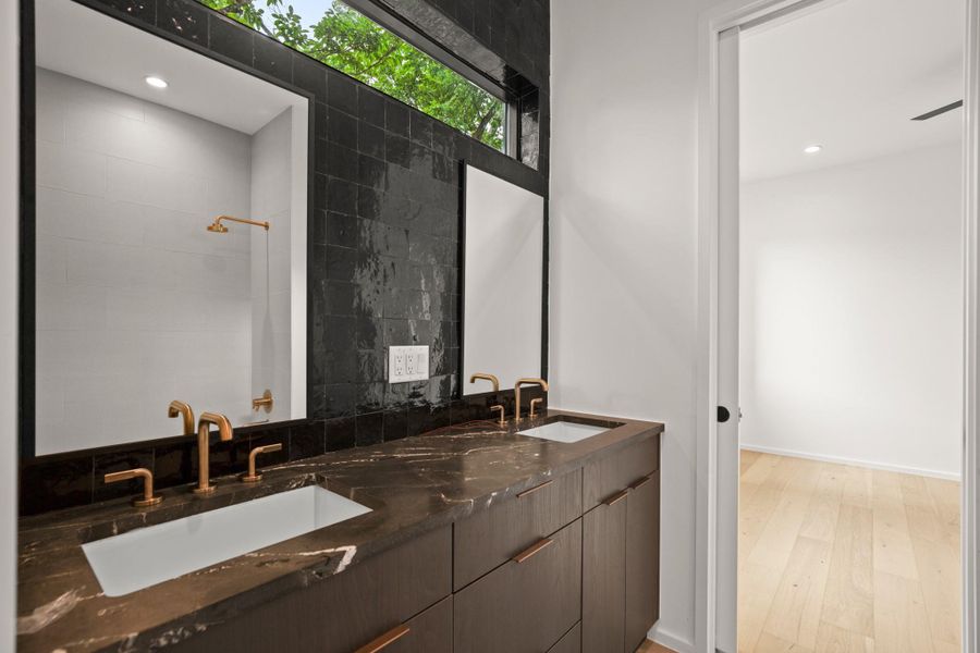Full bathroom with double vanity, recessed lighting, and light wood-style floors