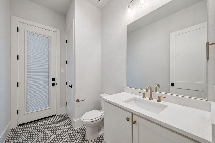 Powder Bath with back door leading to the Backyard - Perfect Pool Bath! *this photo has been edited to show the blinds closed.