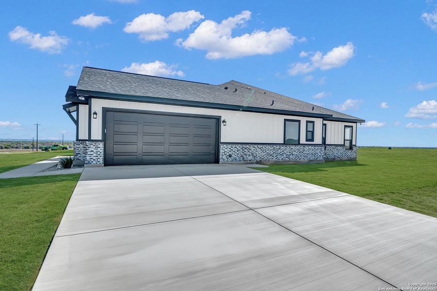 Front exterior of a new home in , La Vernia, TX, highlighting curb appeal (Image 32).