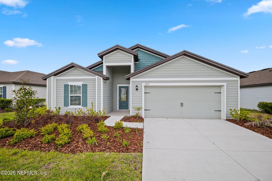 Front exterior of a new home in Westport Landing, Jacksonville, FL, highlighting curb appeal (Image 22).