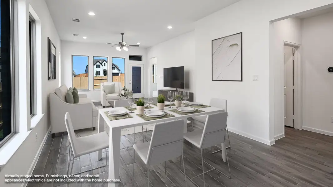 Dining space featuring recessed lighting, dark wood-style flooring, and a ceiling fan Dining space featuring recessed lighting, dark wood-style flooring, and a ceiling fan