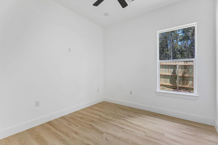 Crisp walls and warm wood flooring define this versatile light-filled space.
