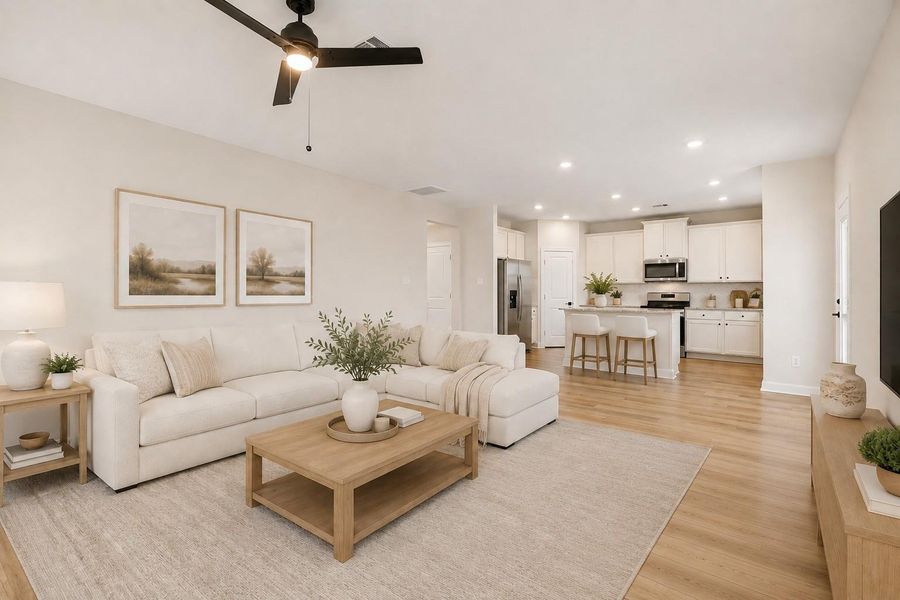 This photo of the open concept living room and kitchen has been virtually staged.
