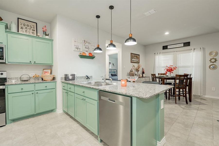 Kitchen with a sink, stainless steel appliances, and green cabinetry