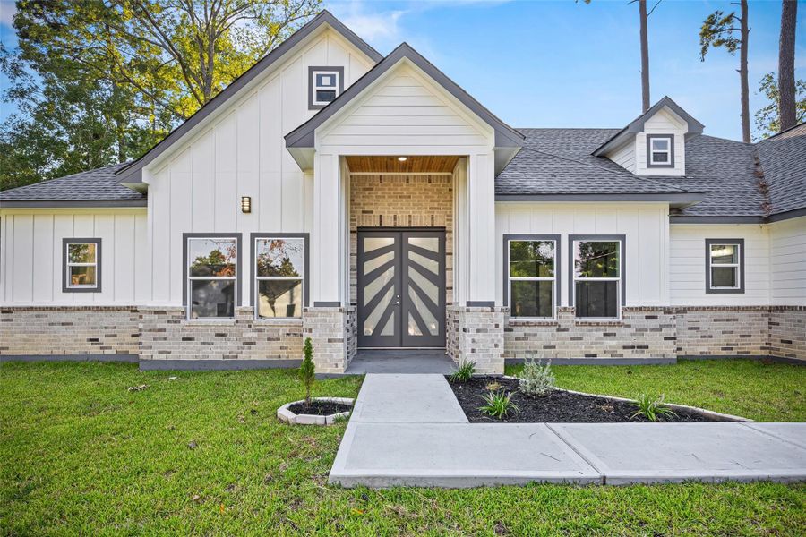 Front exterior of a new home in , Conroe, TX, highlighting curb appeal (Image 1).