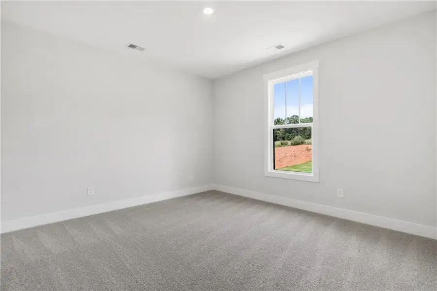 A well-lit, open interior space with fresh carpet A well-lit, open interior space with fresh carpet