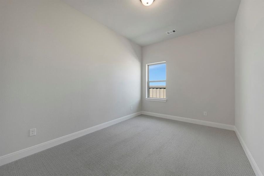Unfurnished room featuring light colored carpet and baseboards