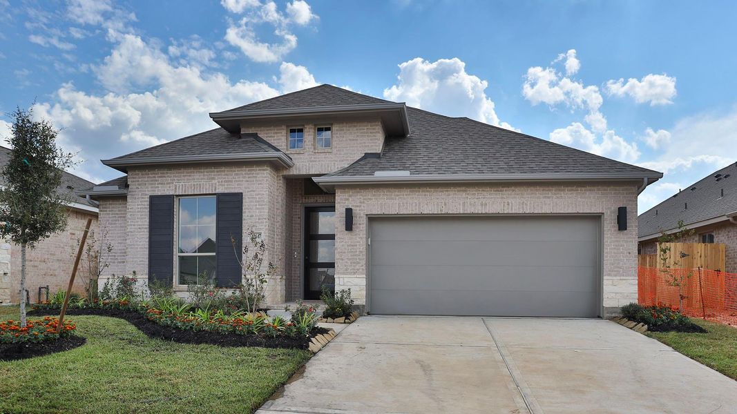 Front exterior of a new home in Escondido 50', Magnolia, TX, highlighting curb appeal (Image 1). Front exterior of a new home in Escondido 50', Magnolia, TX, highlighting curb appeal (Image 1).