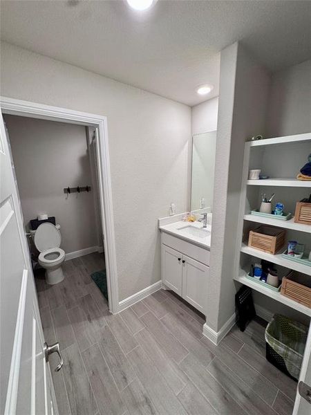 Bathroom 3 vanity area featuring a single basin sink set in a white countertop with a matching white cabinet
