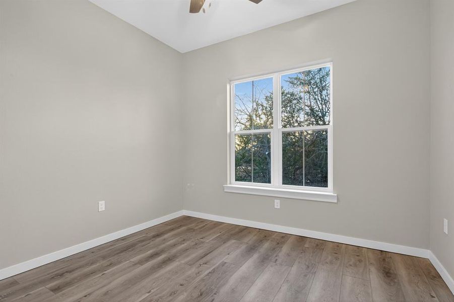 Secondary bedroom with a view has a walk-in closet.
