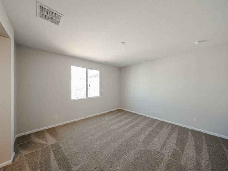 A room with a carpet and a window. A room with a carpet and a window.