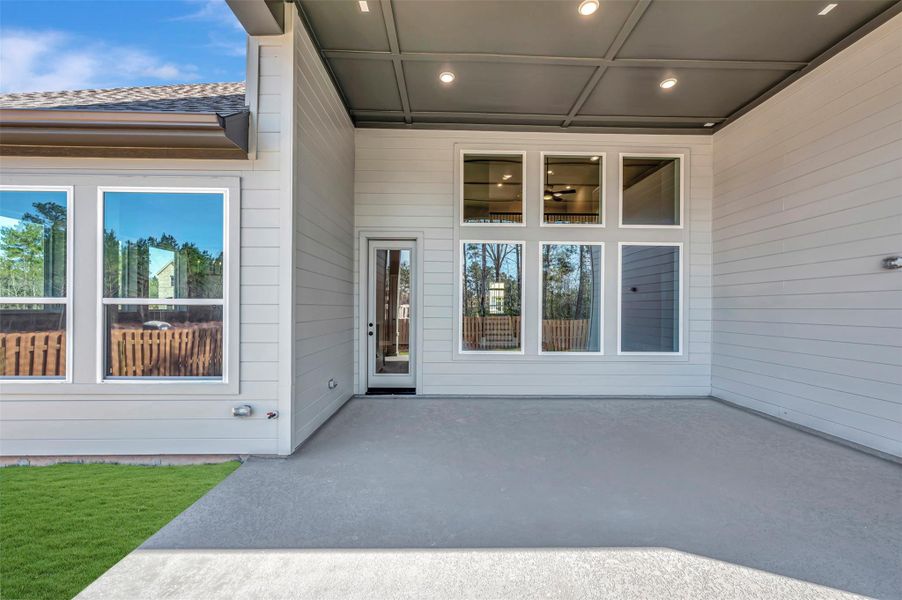 Large covered outdoor living area is plumbed for gas grill and offers a camera pre-wire.