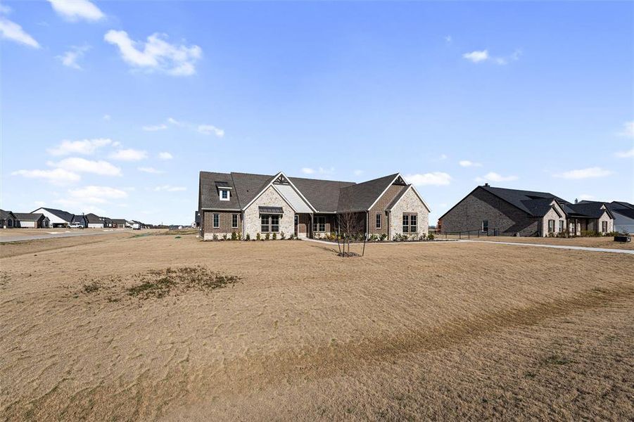 Rear view of house with stone siding and a residential view