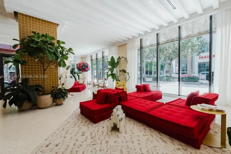 Floor-to-ceiling glass windows, ribbed ceiling detailing, tile-accented structural column, and polished stone flooring Floor-to-ceiling glass windows, ribbed ceiling detailing, tile-accented structural column, and polished stone flooring