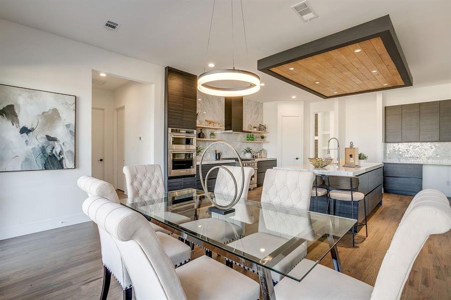 Dining area with light wood-style floors and recessed lighting Dining area with light wood-style floors and recessed lighting
