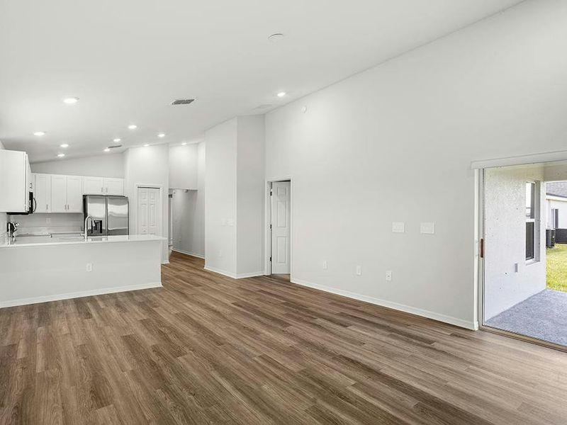 Enjoy a sunny, open living area with airy volume ceilings and low-maintenance LVP flooring.