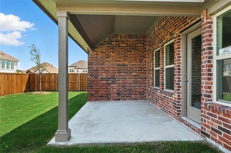 Fenced backyard with a patio area Fenced backyard with a patio area