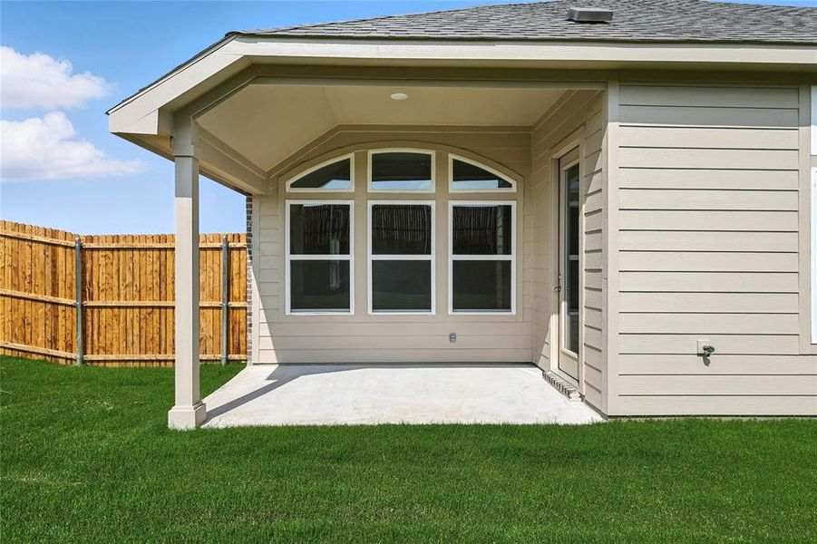 Back of house featuring a patio area and a shingled roof