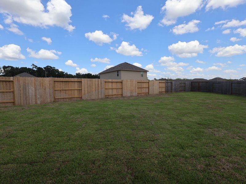 Front exterior of a new home in Pinewood at Grand Texas, New Caney, TX, highlighting curb appeal (Image 25).