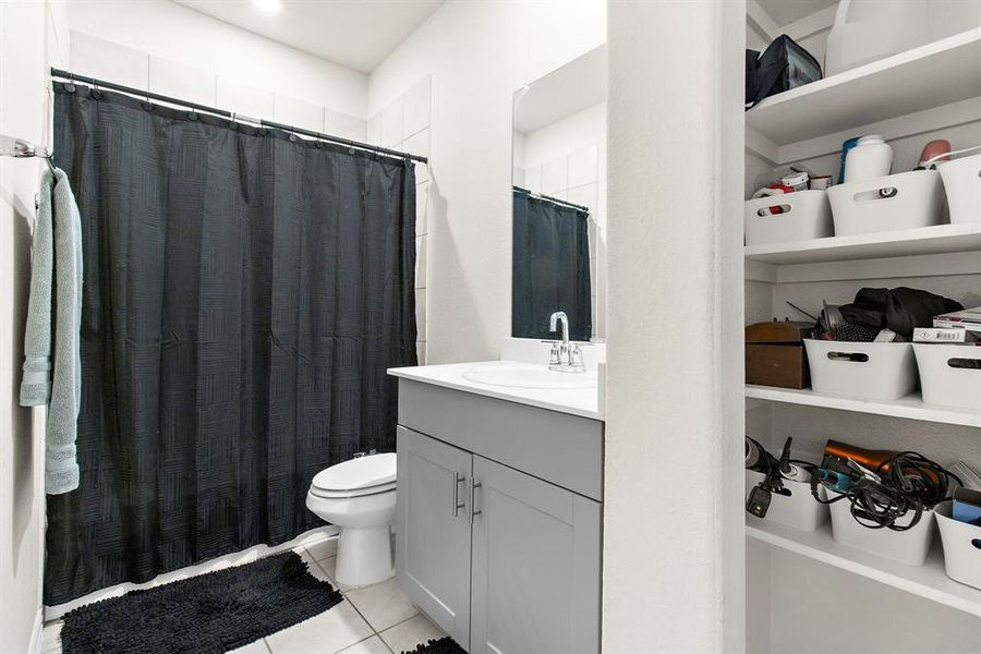 Bathroom with vanity, tile patterned flooring, and a shower with curtain Bathroom with vanity, tile patterned flooring, and a shower with curtain