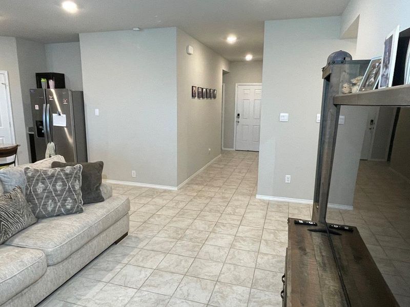Living room featuring baseboards and recessed lighting