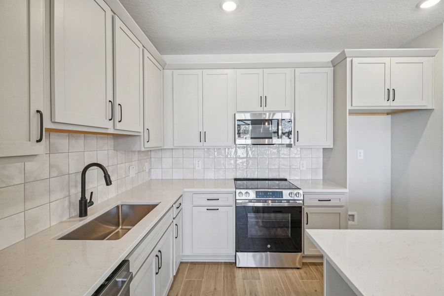 Generous kitchen features stainless steel appliances and ample cabinet storage
