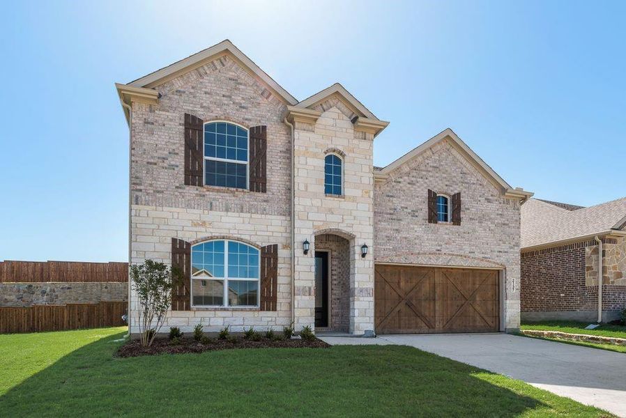 French provincial home with brick siding, a garage, concrete driveway, and stone siding