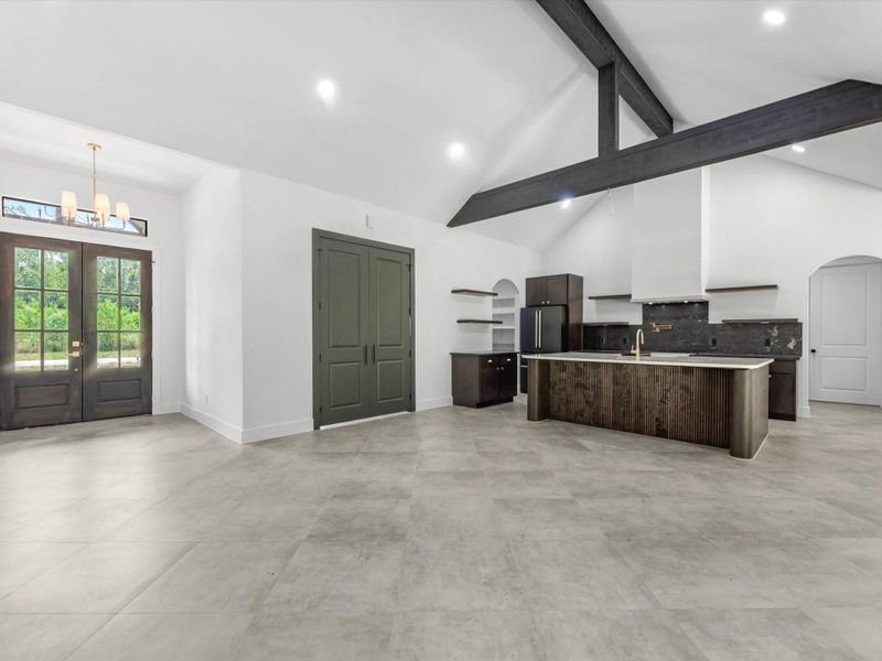 Wow! As you walk in you are greeted with a gorgeous wooden beam and tall ceilings. The 2 sliding doors bring in so much natural light!