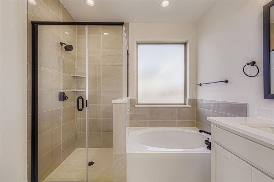 Full bathroom with a bath, vanity, a shower stall, and recessed lighting Full bathroom with a bath, vanity, a shower stall, and recessed lighting