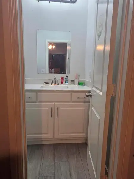 Grand Bathroom with vanity and light wood-style floors