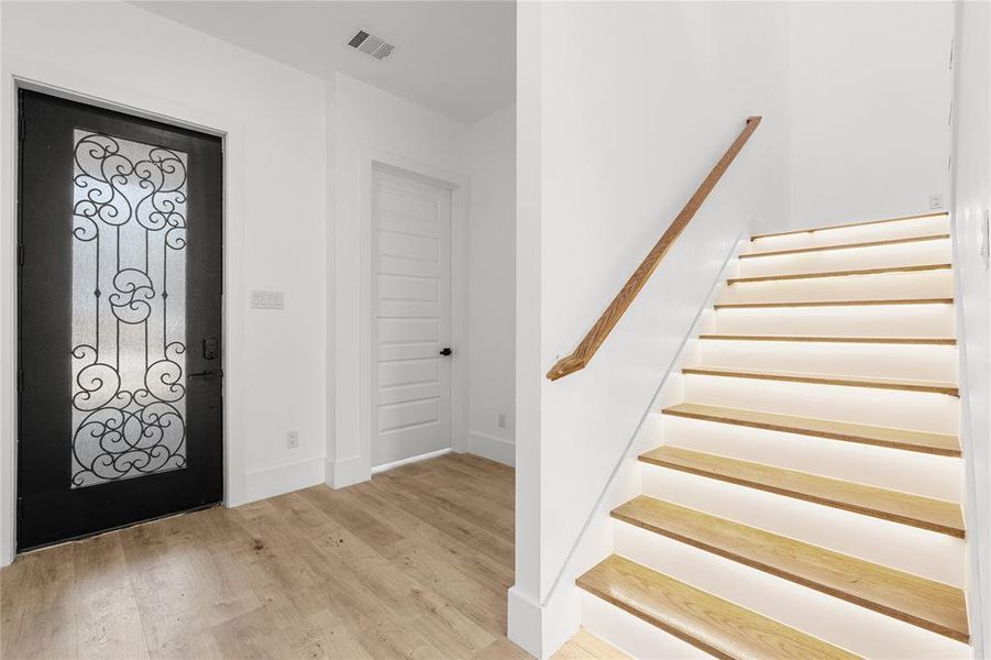 Foyer entrance with stairs and light wood-type flooring Foyer entrance with stairs and light wood-type flooring