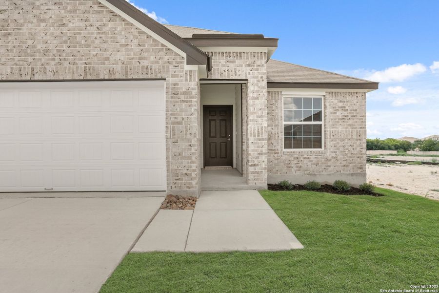 Front exterior of a new home in Hunters Ranch, San Antonio, TX, highlighting curb appeal (Image 19).