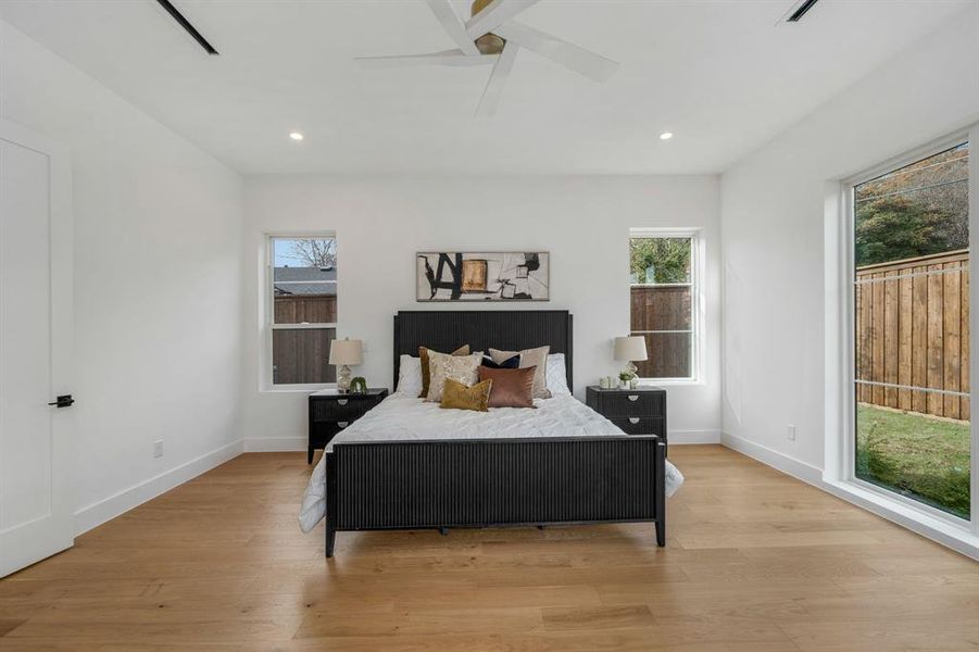 Bedroom with light wood finished floors, recessed lighting, and ceiling fan Bedroom with light wood finished floors, recessed lighting, and ceiling fan