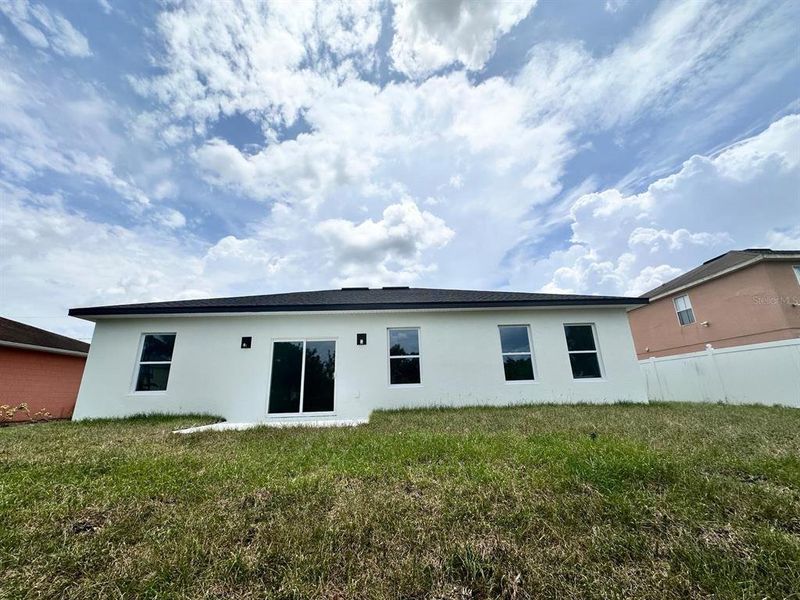 Front exterior of a new home in , Poinciana, FL, highlighting curb appeal (Image 24). Front exterior of a new home in , Poinciana, FL, highlighting curb appeal (Image 24).