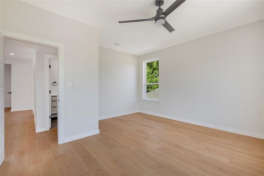 Spare room with ceiling fan and light wood-type flooring