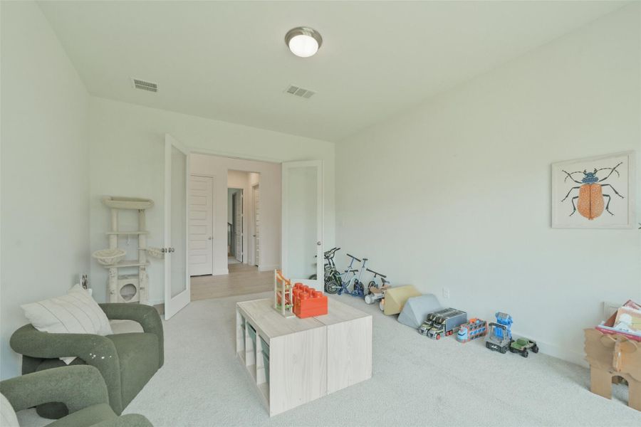 Large game room with double glass doors.