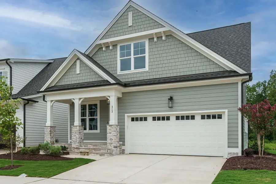 Front exterior of a new home in Wendell Falls, Wendell, NC, highlighting curb appeal (Image 6). Front exterior of a new home in Wendell Falls, Wendell, NC, highlighting curb appeal (Image 6).