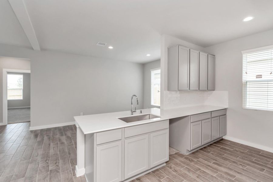 Another perspective of the spacious kitchen. Sample photo of completed home with similar floor plan. Actual colors and selections may vary.