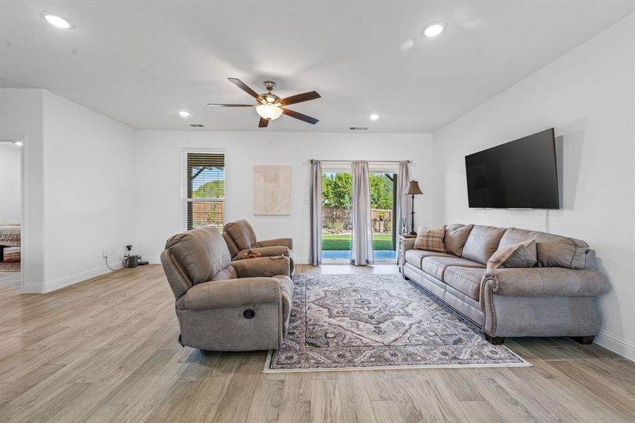 Living room featuring plenty of natural light, recessed lighting, light wood-style flooring, and ceiling fan