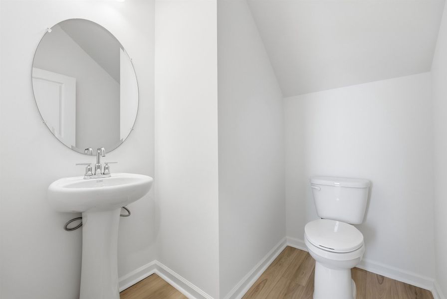 Bathroom featuring lofted ceiling and light wood finished floors Bathroom featuring lofted ceiling and light wood finished floors