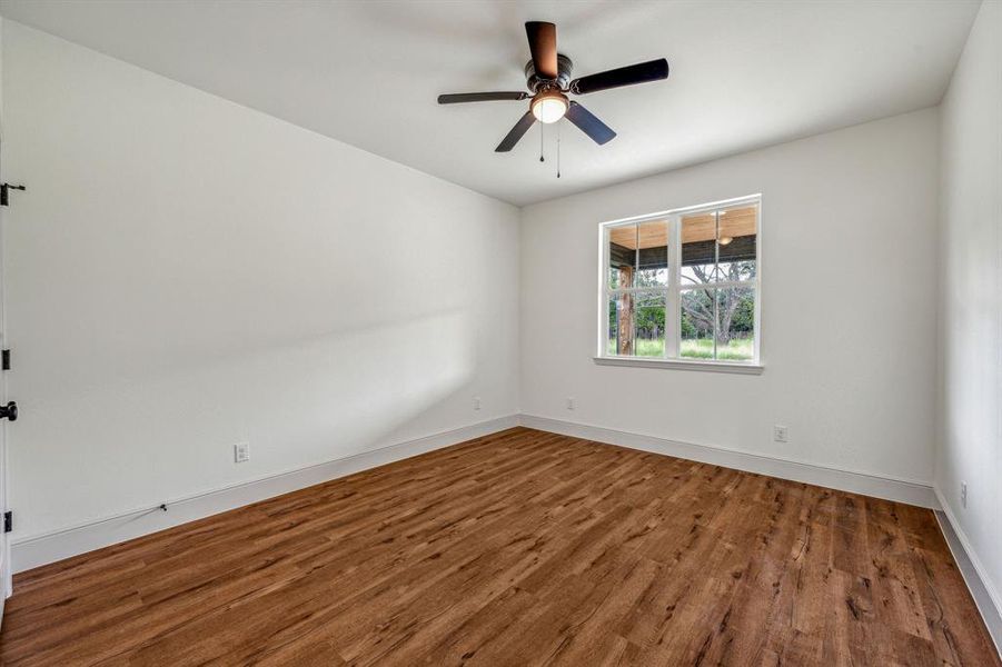 Unfurnished room featuring ceiling fan and wood-type flooring