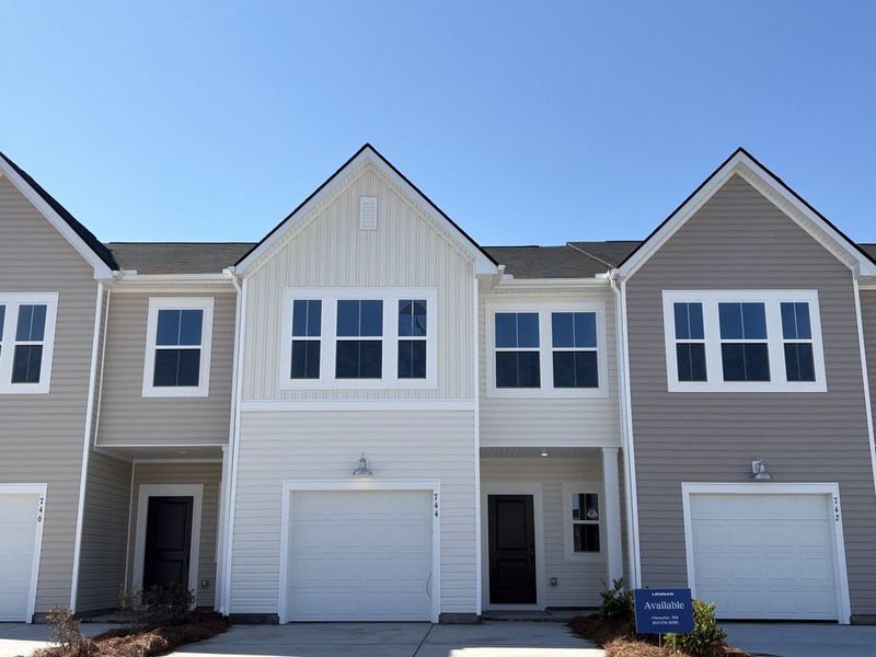 Front exterior of a new home in Lindera Preserve at Cane Bay Plantation, Summerville, SC, highlighting curb appeal (Image 1). Front exterior of a new home in Lindera Preserve at Cane Bay Plantation, Summerville, SC, highlighting curb appeal (Image 1).