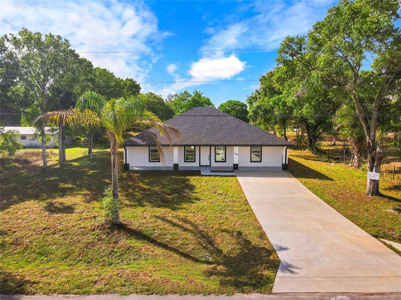 Front exterior of a new home in , Okeechobee, FL, highlighting curb appeal (Image 19).