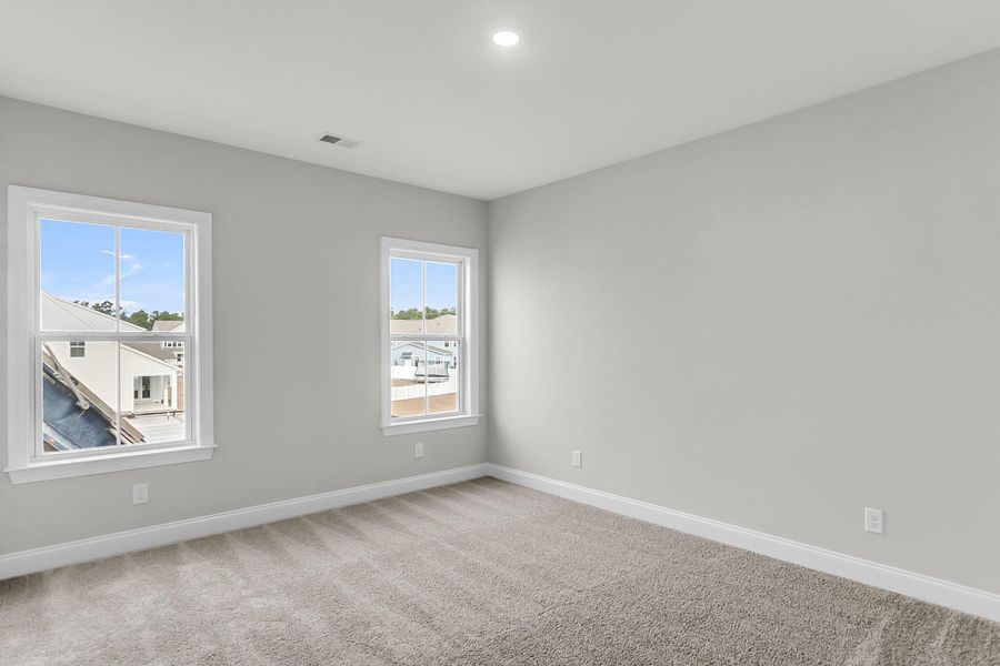 Spacious, unfurnished interior of a new home in Tidewater at Lakes of Cane Bay, Summerville (Image 47).