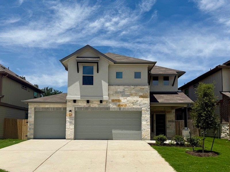 Front exterior of a new home in The Hills of Bear Creek, Manchaca, TX, highlighting curb appeal (Image 3).